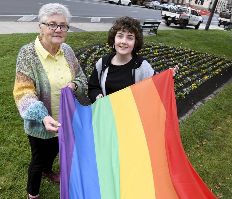 SUPPORT: Anne Tudor and Paige Thomas prepare to raise the rainbow flag outside Ballarat Town Hall to mark IDAHOBIT, celebrating diversity and challenging the community to end discrimination of LGBTIQA+ people. Picture: Lachlan Bence