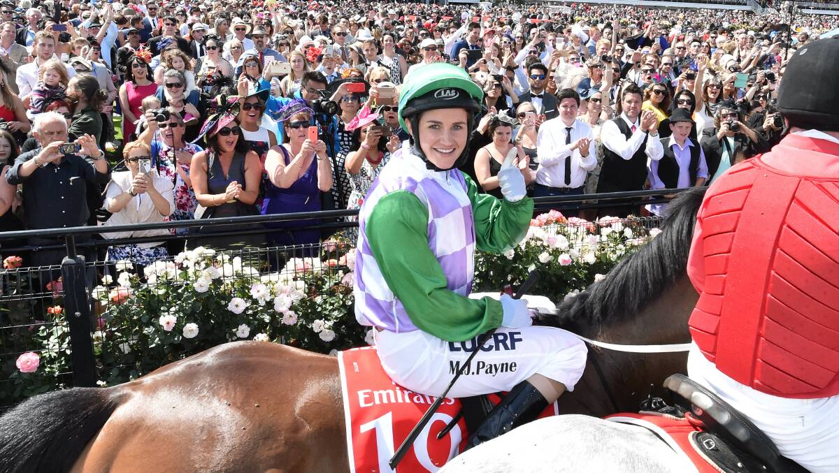 DEFINING: Historic moment as Michelle Payne celebrates winning the 2015 Melbourne Cup, proving an Australian jockey could "beat the world". Picture: The Age