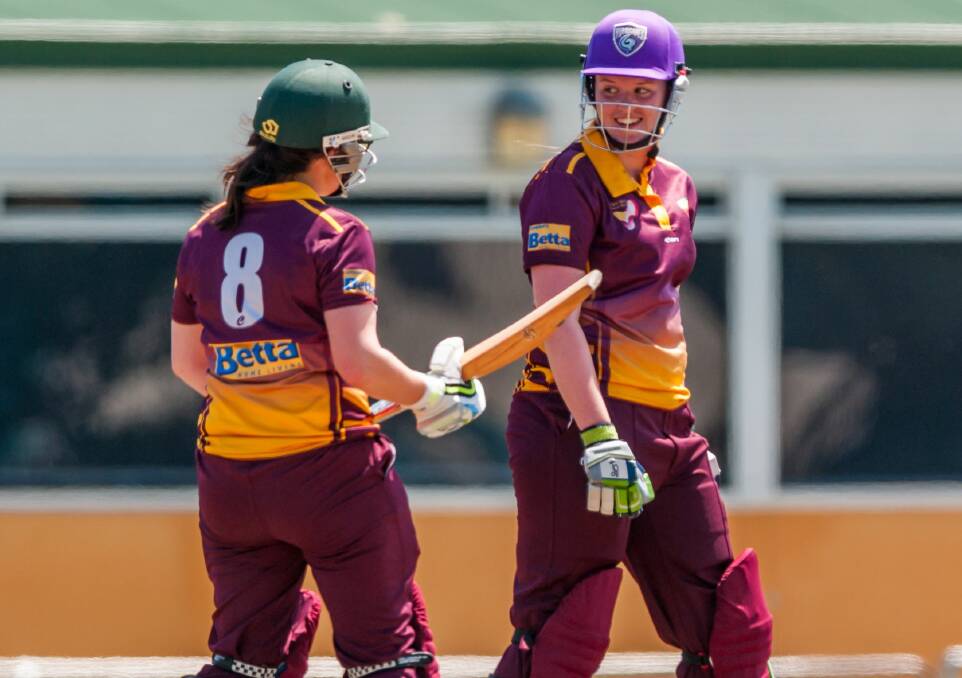 TOO EASY: North West batters Sam Cotton and Madeleine Clarke share a casual laugh in the middle between balls in the intrastate clash with the North. Picture: Phillip Biggs