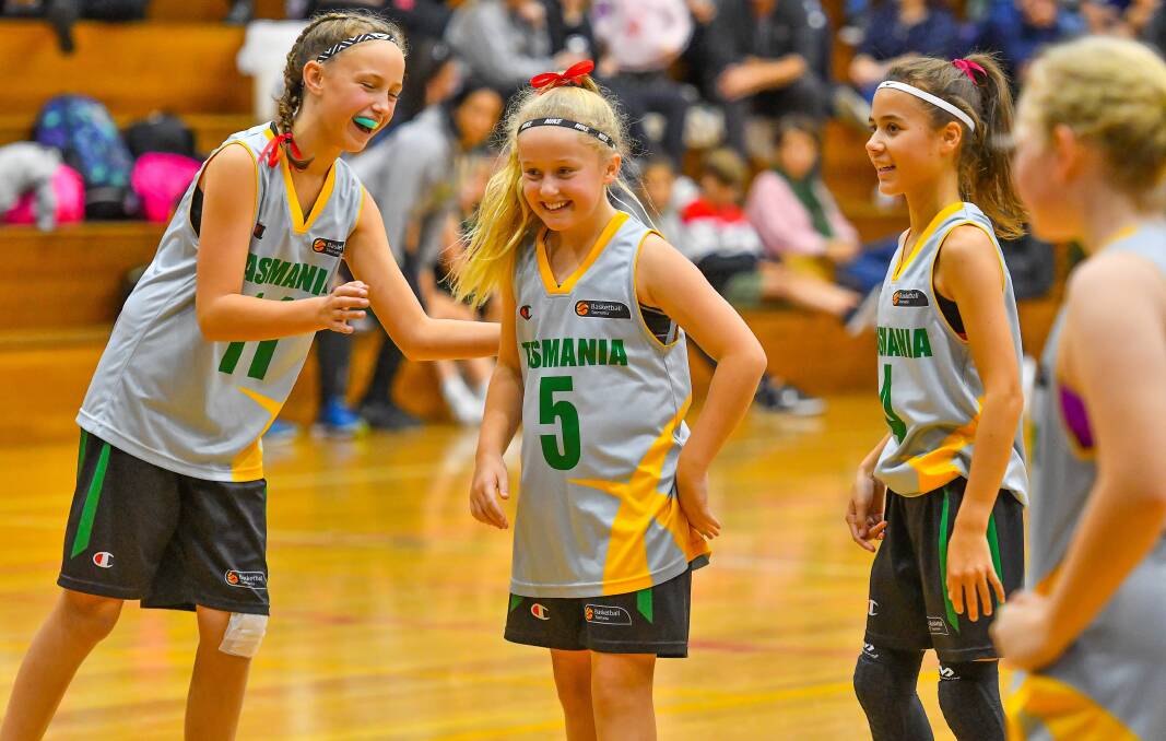 FUN TIMES: Lucy Aherne, Mia Aylett and Jade McCoy share a laugh on the court. Pictures: Scott Gelston