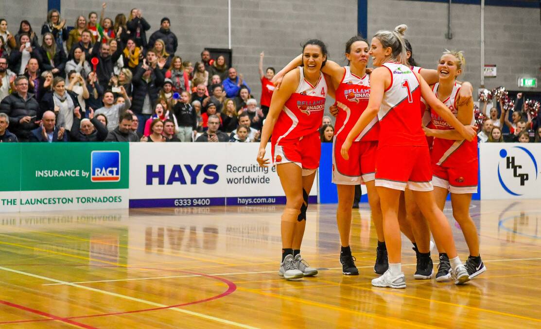 GRAND FINAL BOUND: Launceston Tornadoes teammates start celebrations during the final minute of last Saturday's preliminary win over Nunawading at Elphn Sports Centre. Picture: Scott Gelston