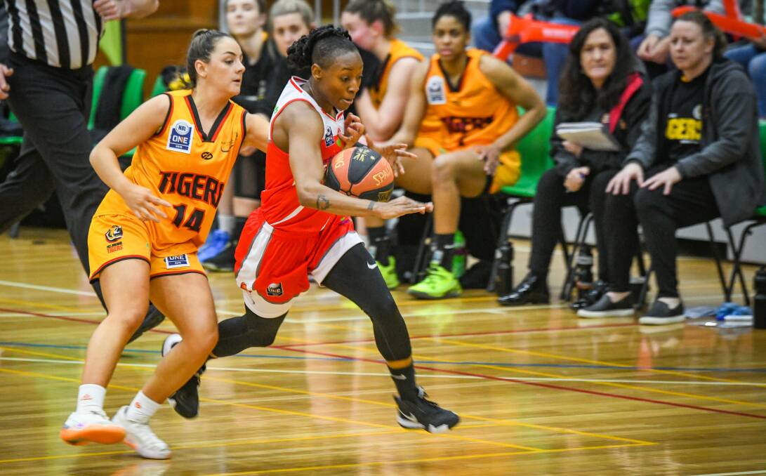 BURSTING: Tornadoes import Steph Gardner looks to escape the close attention of Melbourne Tiger Monique Conti in Friday night's opening clash of the NBL1 double-header at Elphin Sports Centre. Picture: Paul Scambler