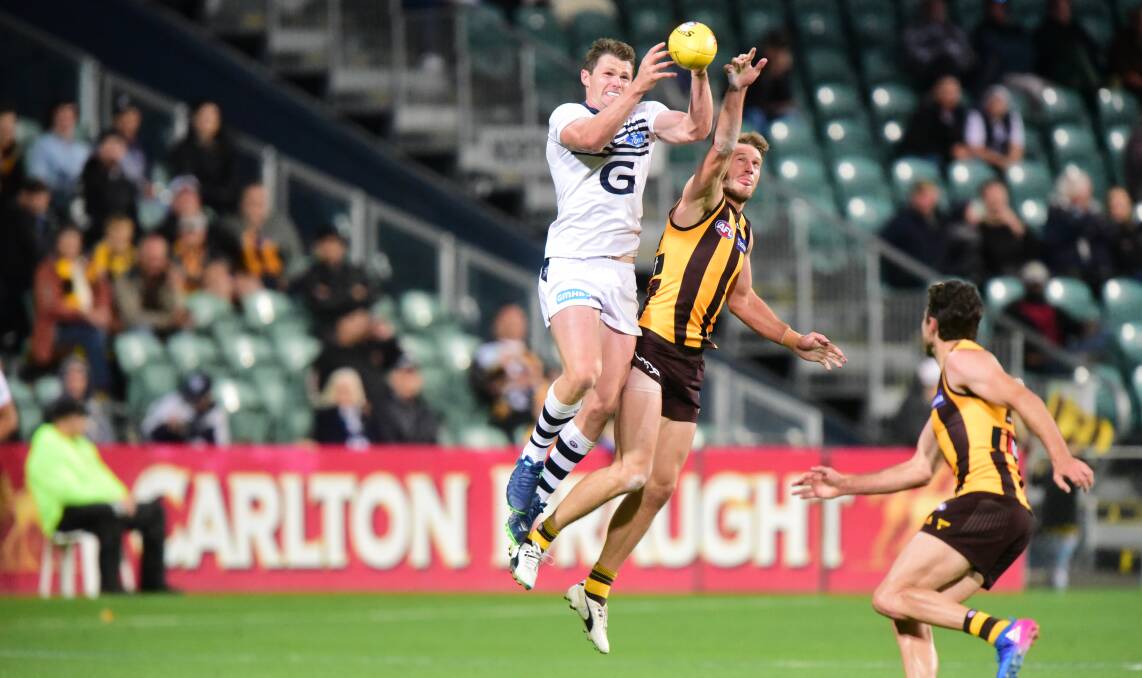 STRENGTH: Geelong superstar Patrick Dangerfield leads Tasmanian Grant Birchall in a lead to the ball in the JLT Community Series clash. 