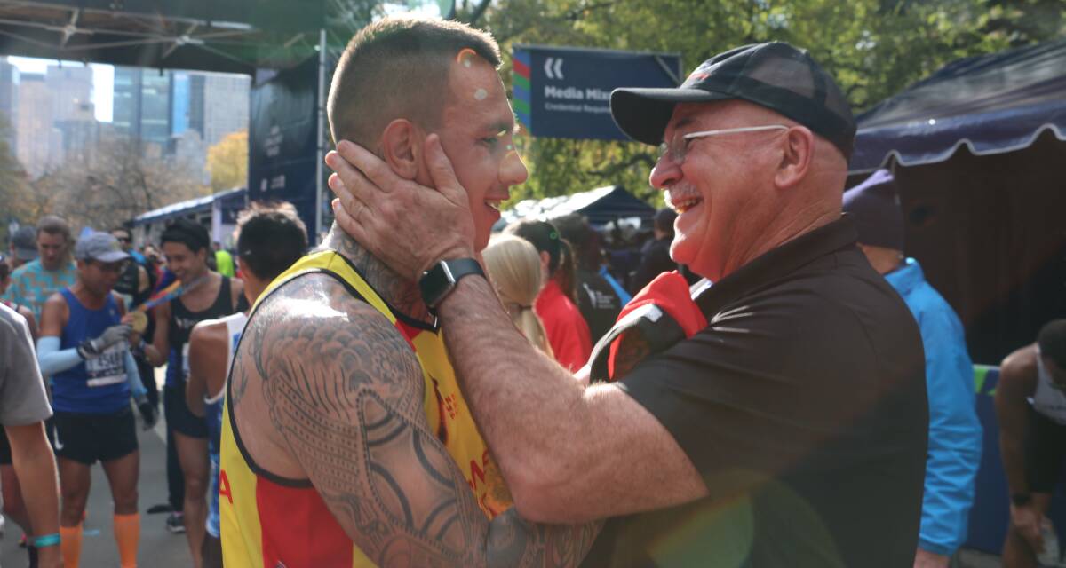 YOU BEAUTY: Robert de Castella embraces Shane Cook at the finish line of the New York Marathon.