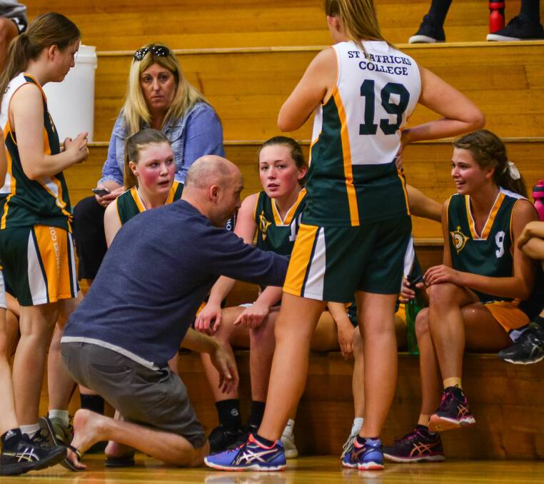 LISTEN UP: St Patrick's College Launceston get some words of advice during a time-out of their group match.