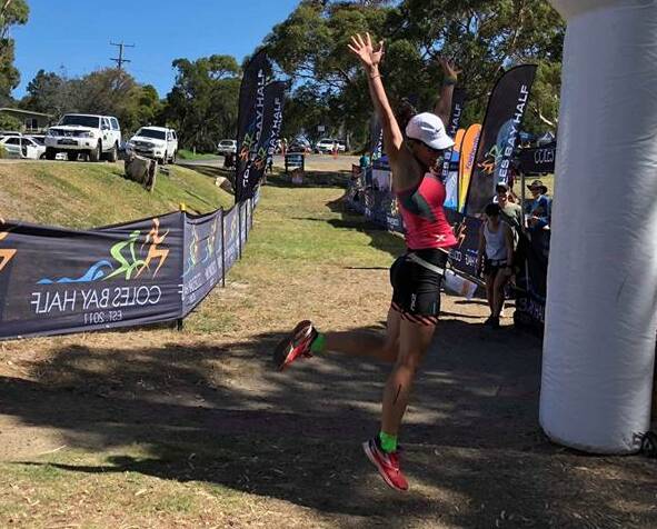 FINALLY: Jubilant Mel Clarke jumps for joy after winning the women's Coles Bay Half ironman on Saturday after more than five hours. Picture: Supplied