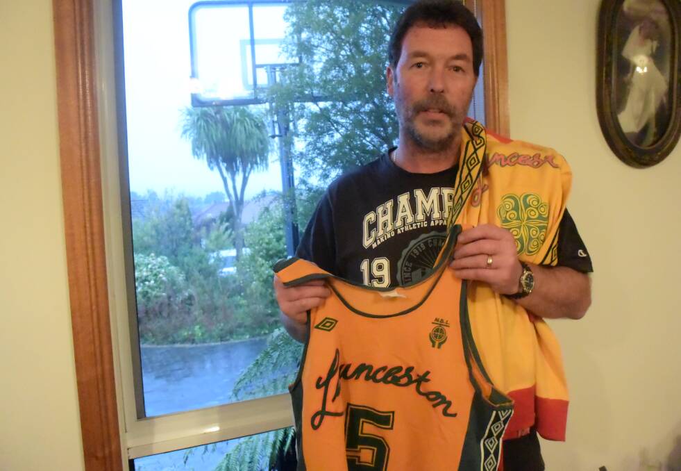 SENTIMENTAL: One-time Launceston Casino City Tigers young talent Dean Draper pulls out some of his 1981 NBL championship playing gear from inside his Norwood home. Picture: Andrew Mathieson