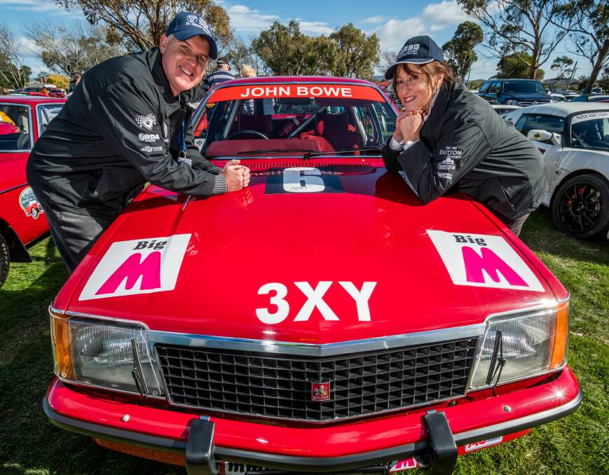 RED HOT: Andrew and Janine Bond show off their conspicuous John Bowe touring car that brought on several glances at George Town on Monday. Picture: Phillip Biggs. 