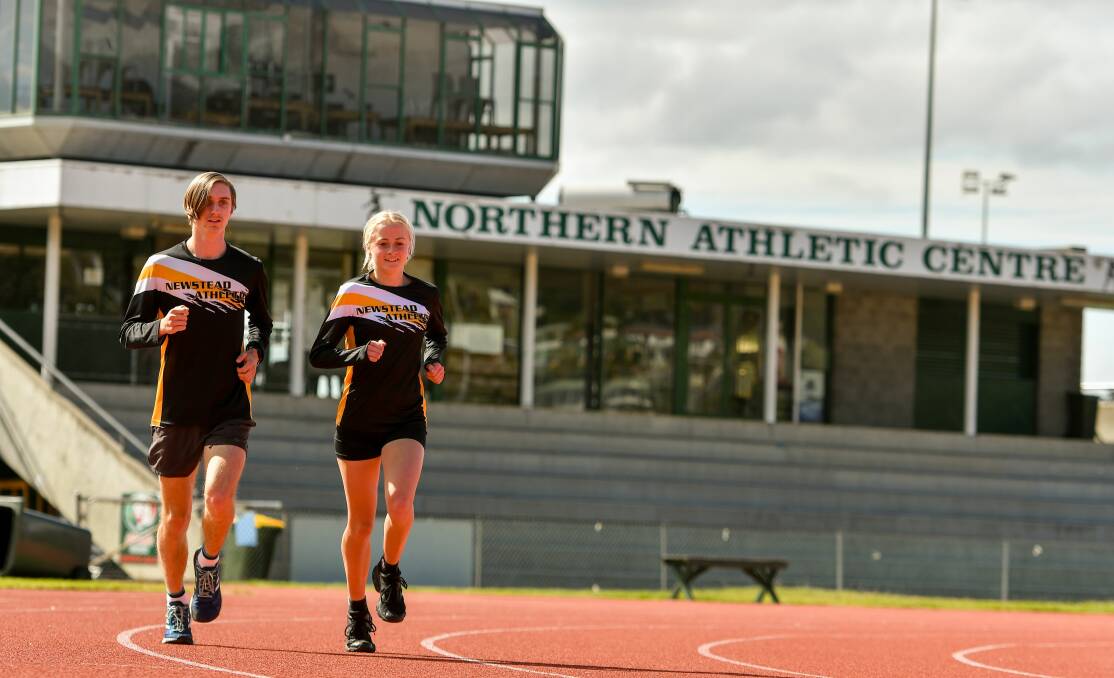 ON TRACK: Sam Clifford and Abbie Butler stretch out between competition. Pictures: Scott Gelston