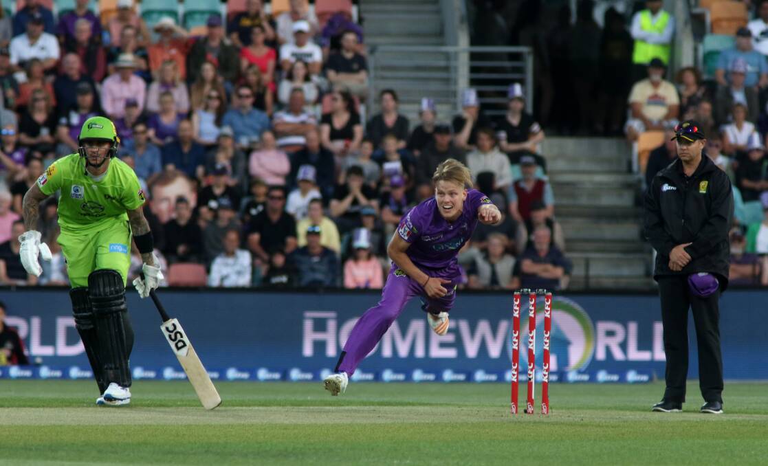 EFFORT: Hobart Hurricanes firebrand Nathan Ellis puts everything into his delivery stride, as Sydney Thunder opener Alex Hales watches on during Thursday night's Big Bash eliminator at Bellerive Oval. Picture: Rick Smith