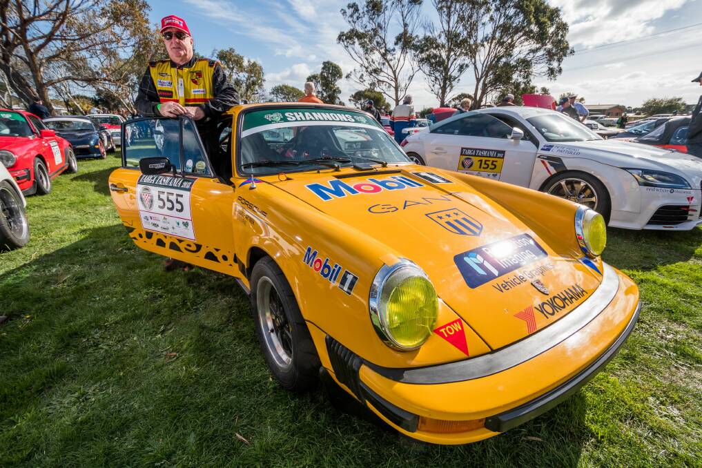 SHE'S A BEAUT: Targa race veteran Geoff Taylor shows off his Porsche for fans at the pre-race rally in George Town. Pictures: Phillip Biggs