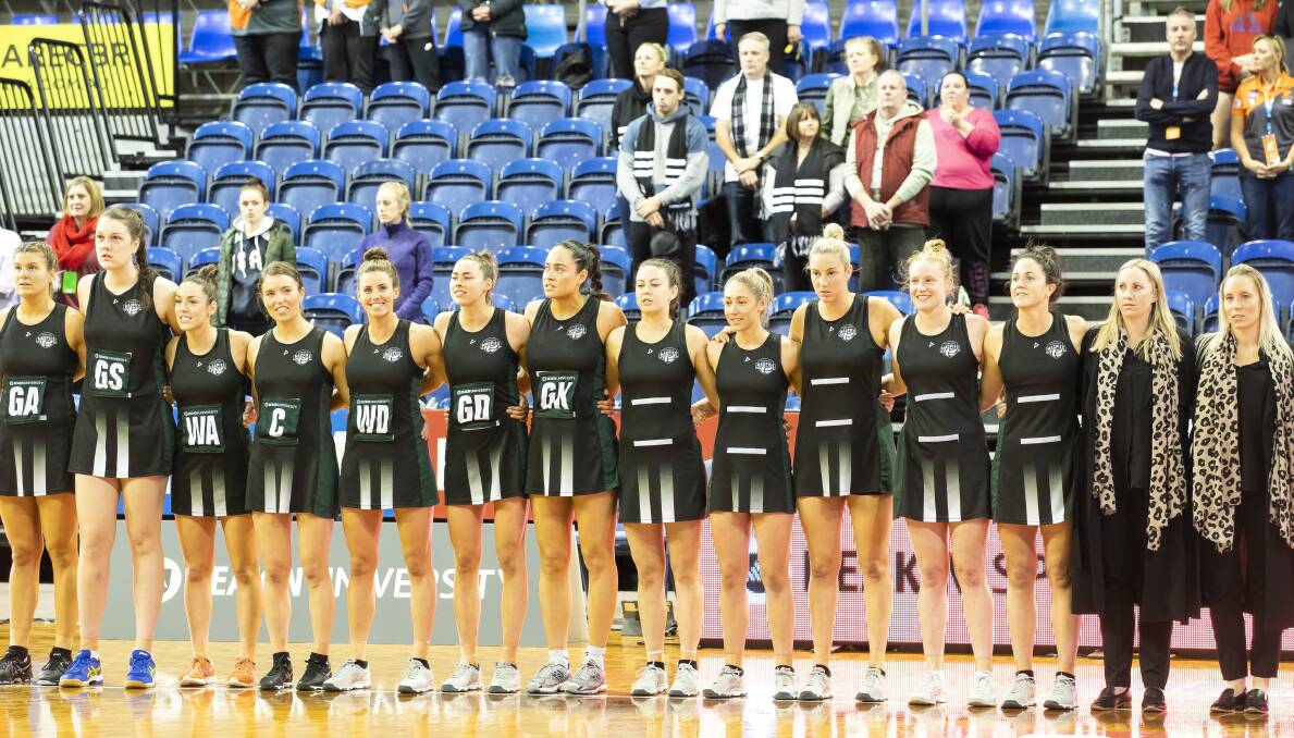 STATES UNITED: Tasmanian Magpies, with assistant coach Claire Dennis (far right), line up for the national anthem before the 2018 ANL grand final in Canberra. Pictures:  Sitthixay Ditthavong