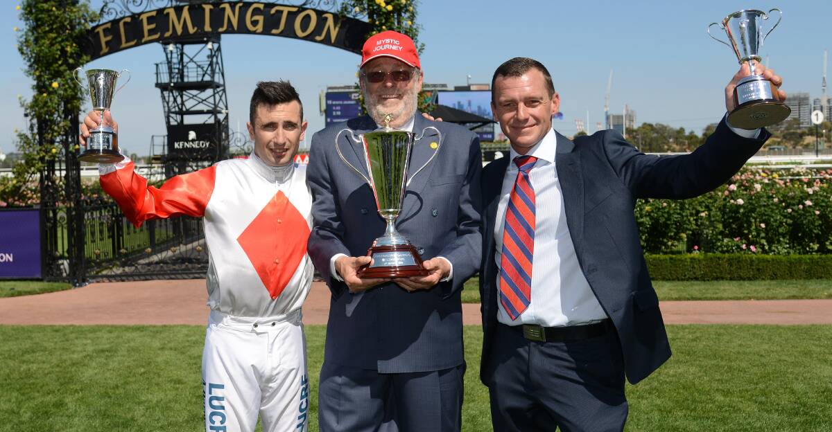 WE DID IT: Jockey Anthony Darmanin, owner Wayne Roser and trainer Adam Trinder celebrate after Mystic Journey takes out the rich Australian Guineas. Picture: AAP