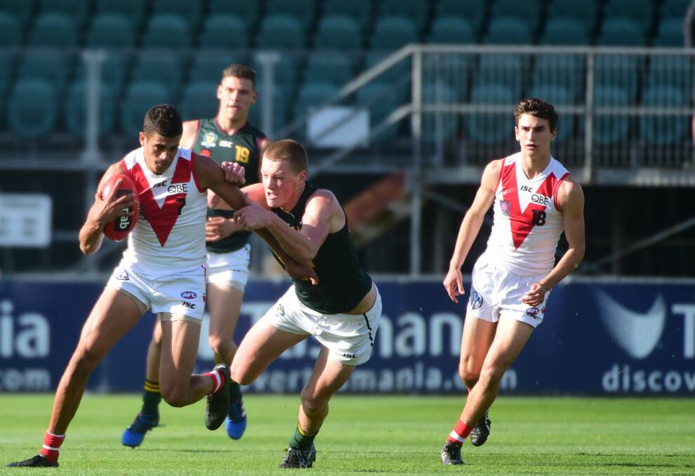 COMPETITOR: Big Tasmanian Hugh Dixon in the thick of it for the Mariners under-18s against the Sydney Swans academy.