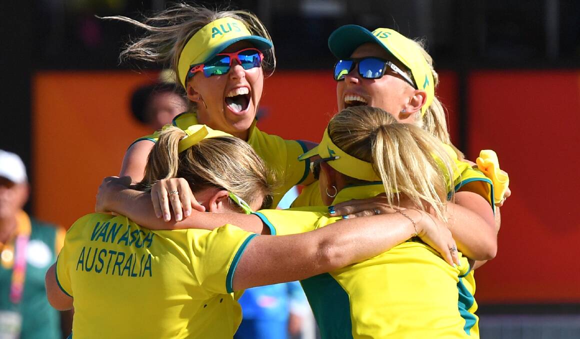 JOYOUS: Invermay bowler Rebecca Van Asch, left, joins her Australian teammates in wild celebration. Picture: AAP