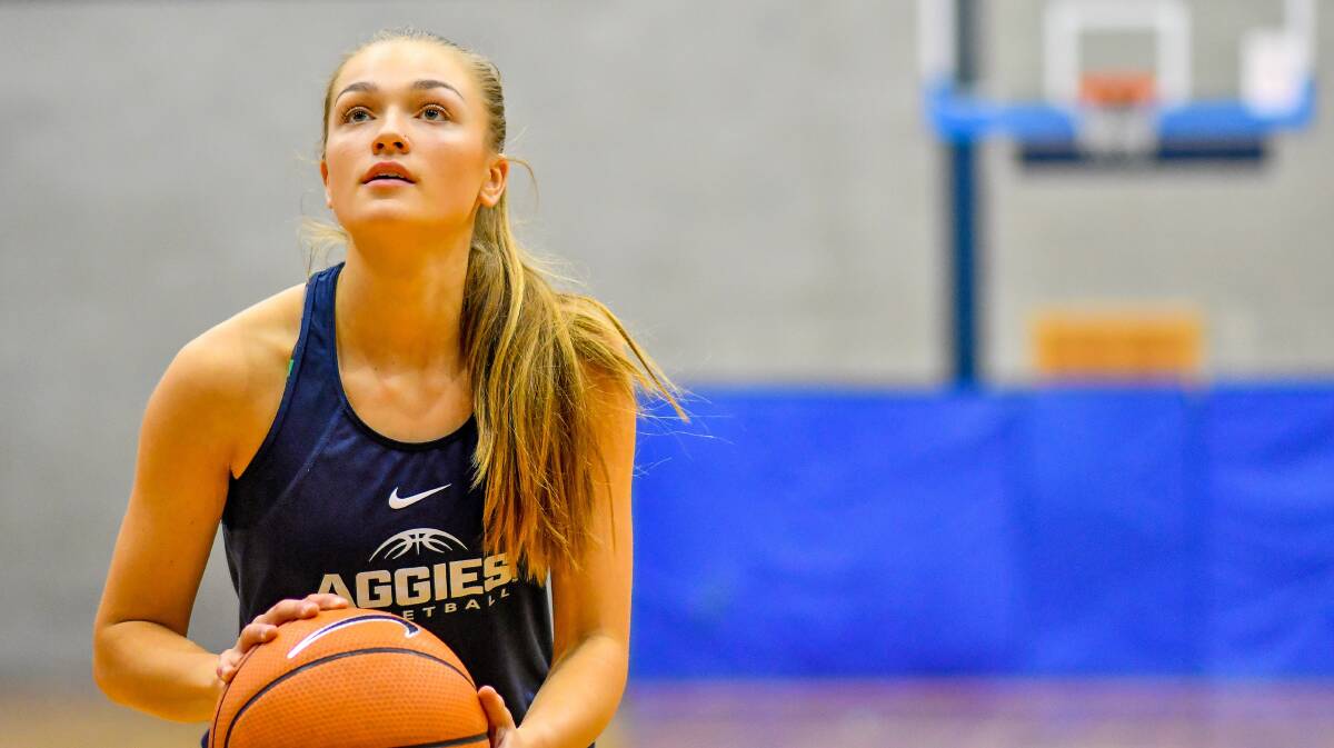 STAND-OUT: West is a world away from the packed, big stadiums that greet her playing for Utah State Aggies.

