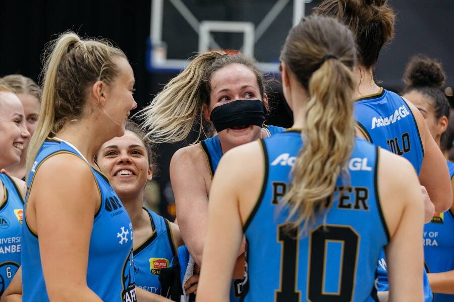 PLAY THROUGH: An injured Keely Froling gathers with UC Capitals teammates during the overtime win. Picture: WNBL