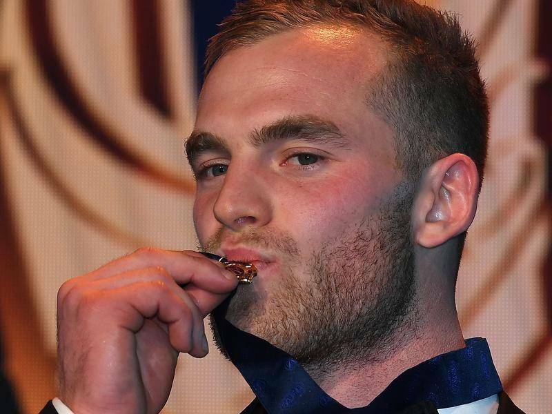HAPPIER TIMES: Tom Mitchell kisses his Brownlow Medal last year.