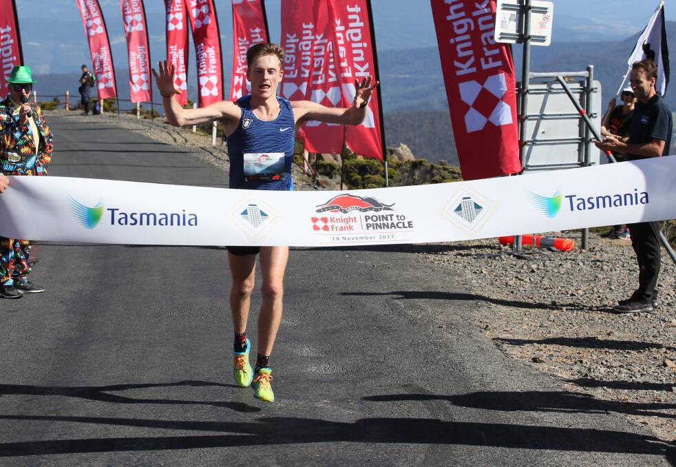 BIG EFFORT: Defending Point to Pinnacle champion Dylan Evans crosses the finish line during last year's run on top of Mt Wellington. Picture: Supplied