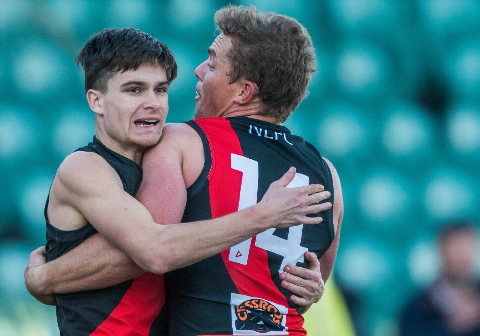 YOUNG AND OLD: North Launceston youngster Sherrin Egger embraces ex-coach Tom Couch. Picture: Phillip Biggs