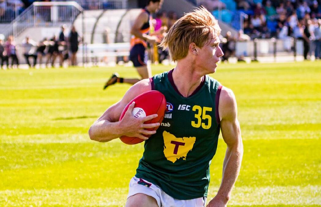 LOOKOUT: Tasmanian Devils defender Liam Viney surveys the ground with ball in hand. Picture: Supplied