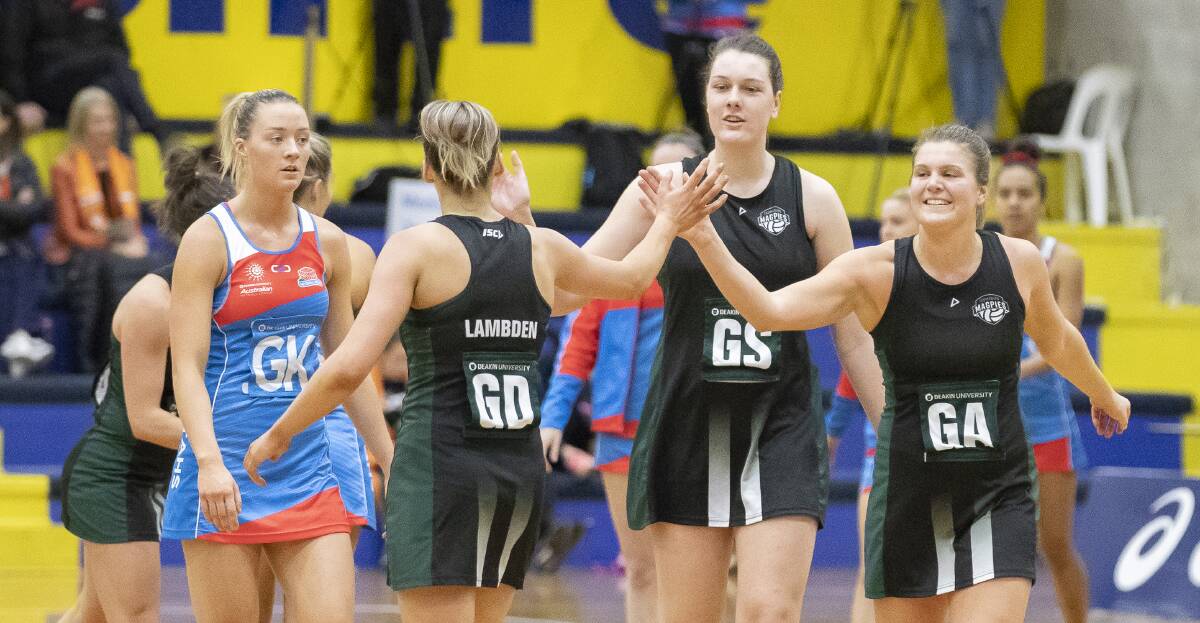ON SONG: Tasmanian Magpies Cody Lange and Sharni Lambden swap high fives in the win. Picture: Daniel Briggs