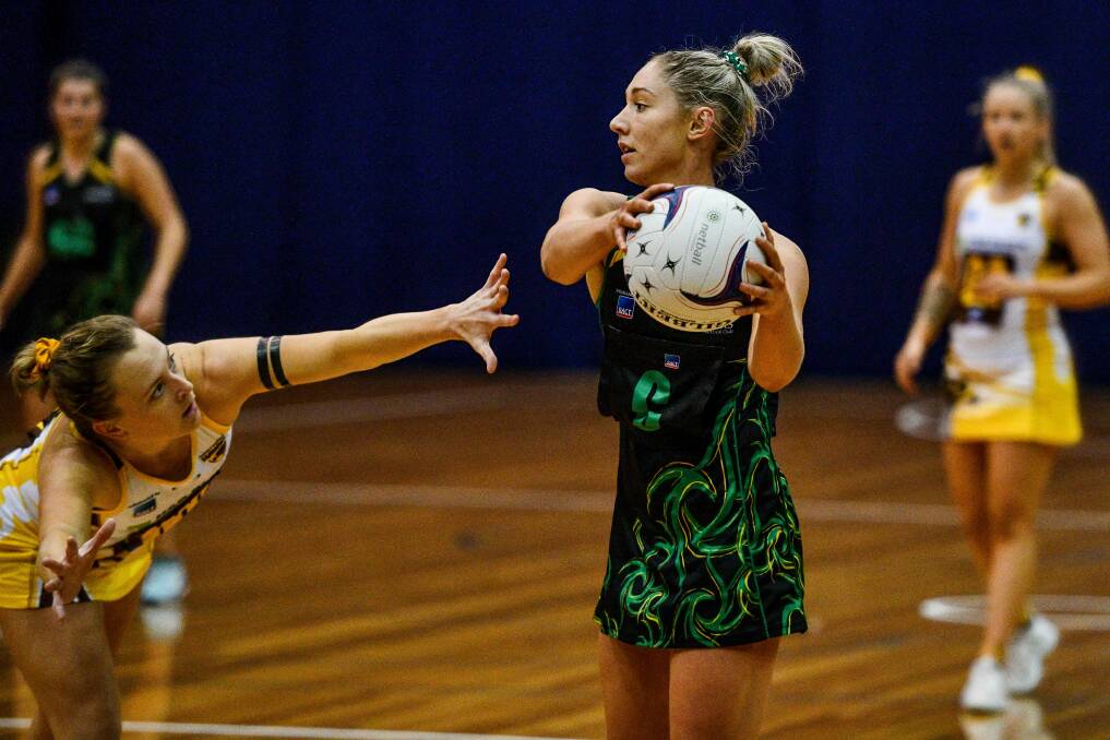 PLAYMAKER: Cavaliers midcourter Shelby Miller looks to push the next pass past desperate Northern Hawks defender Ashton Whiley on Saturday in a player-of-the-match grand final performance at the Silverdome. Pictures: Scott Gelston