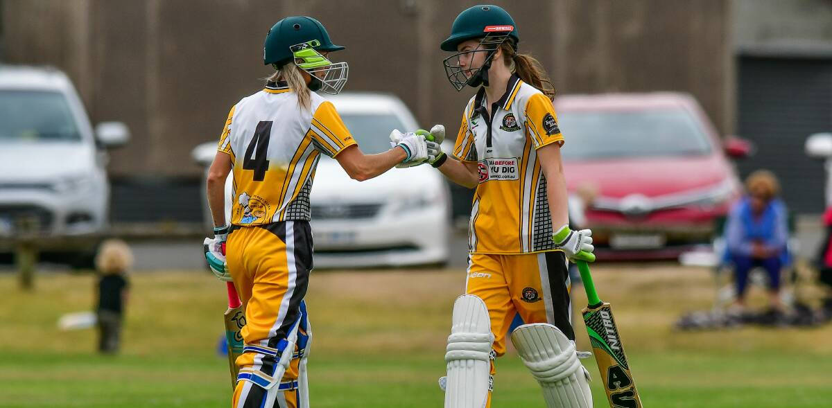 TEAM UP: Tigers pair Kristy Clayton and Emma Humphries fist bump in the middle of the pitch during last season's grand final. Pictures: Scott Gelston