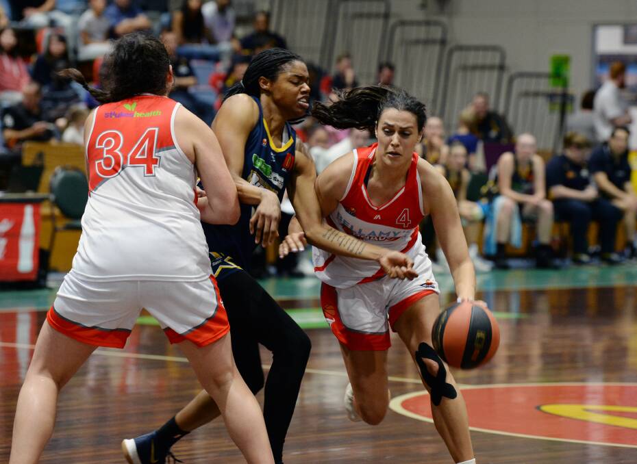 ATTENTION: Launceston guard Ally Wilson looks to slide past the tight Ballarat defence  on Sunday, as Ellie Collins puts on a block for her Tornadoes teammate. Picture: Kate Healy