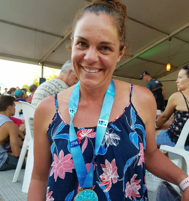 GREAT REWARD: Launceston triathlete Heidi Edmiston takes in the medal presentation on Sunday after the Noosa race. Picture: Supplied.