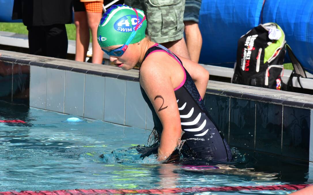 HITTING THE WALL: Casey Bumford touches down in the swim leg at the George Town Triathlon.