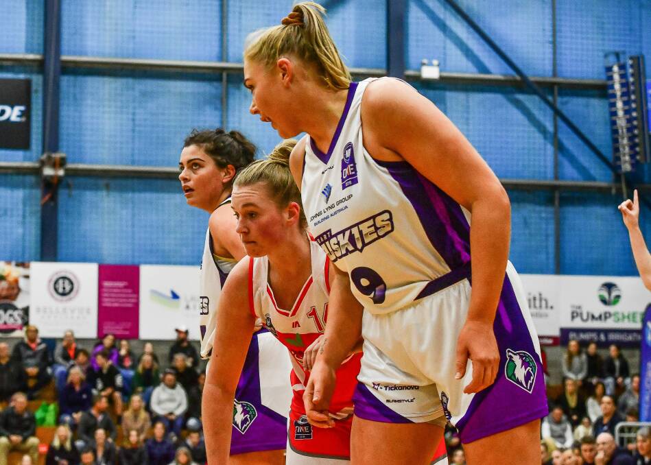 SIED BY SIDE: Former Tornadoes pair Ellie Collins and Tayla Roberts square up next to Sarah O'Neil at the free-throw line. 