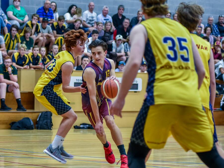 CLOSE QUARTERS: Scotch Oakburn's Henry Cox look to stop Riverside's Cameron Boyden in the year 9/10 grand final during Basketball Tasmania’s North high school championships at Elphin Sports Centre. Picture: Neil Richardson