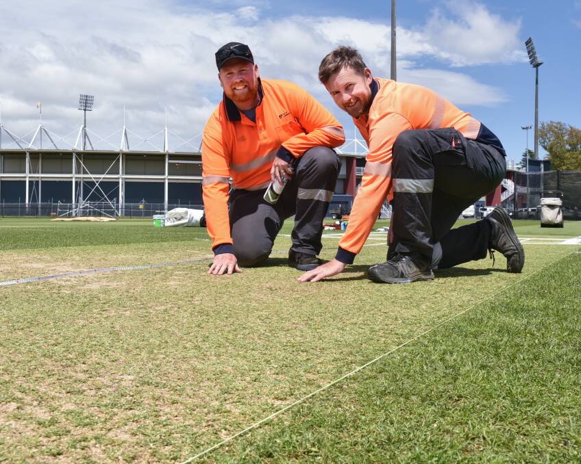 FIRM: Groundstaff Adam Spargo and Grant Woolley prepare the Invermay Park wicket. Picture: Neil Richardson