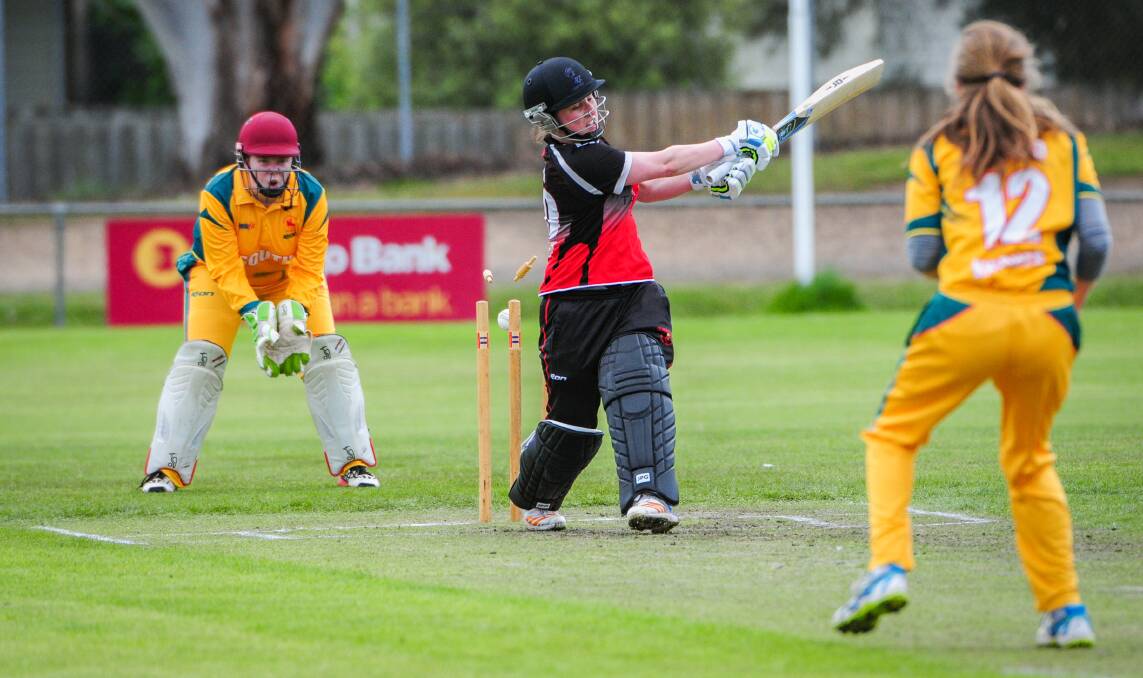 CLEANED UP: South Launceston allrounder Meg Radford runs through Ulverstone captain Sam Cotton in the Sunday clash of Greater Northern Raiders teammates including Knights wicketkeeper Caitlyn Webster. Picture: Paul Scambler