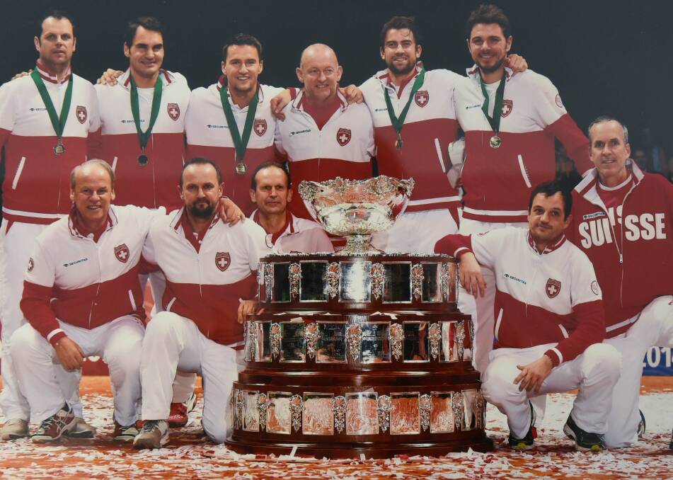 HERE IT IS: Swiss coach David Macpherson celebrates Switzerland, which includes Roger Federer and Stan Wawrinka, for the first time in 2014 win the Davis Cup.