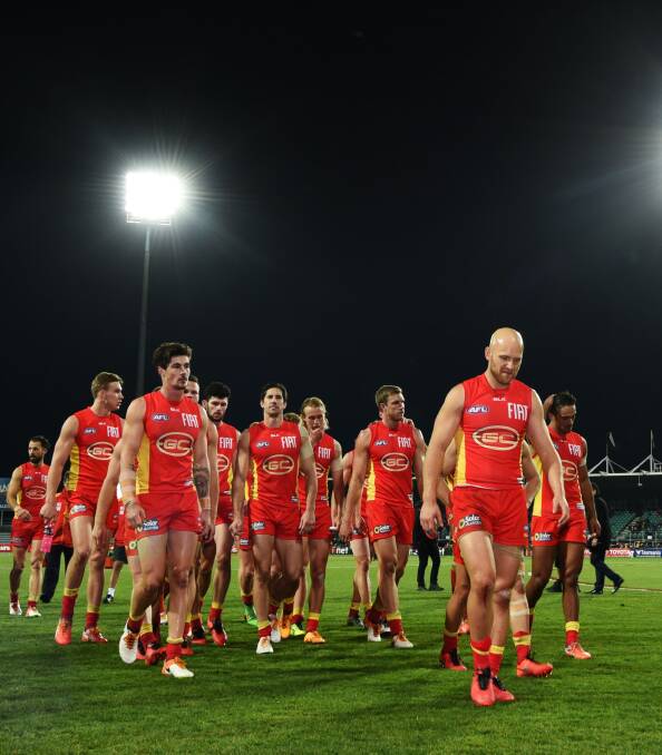 REALITY BITES: Gold Coast captain Gary Ablett leads the Suns players off the ground dejected following the 26-point loss to Hawthorn in Launceston. Pictures: Scott Gelston