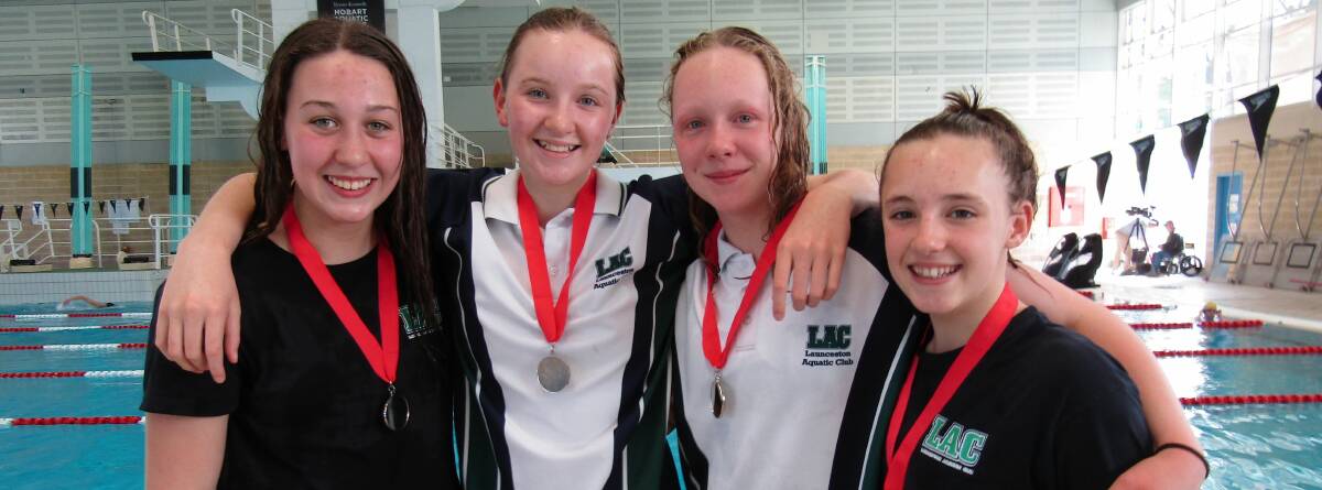 SWIMMERS FOR LIFE: Standout swimming prospect Mackenzie French with her friends in the pool, Ellie Muller, Amy Muldoon and Jade Nichols, at Hobart Aquatic Centre. 