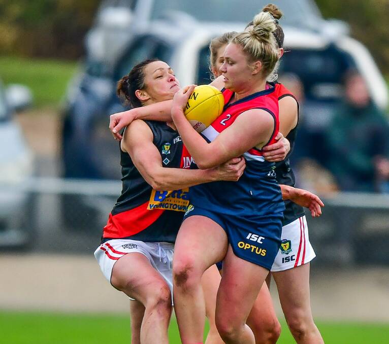 CIVIL WAR: Bomber enforcer Renee Wilson tackles star Blue Daria Bannister in the only previous time the crosstown rivals have battled ahead of the next TSLW clash on Sunday afternoon at UTAS Stadium. Picture: Scott Gelston