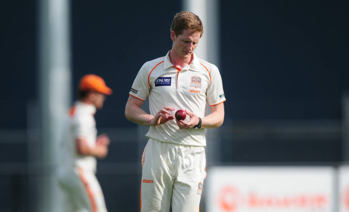THOUGHTFUL: Wicket-taker Tom Gray walks back to his mark.