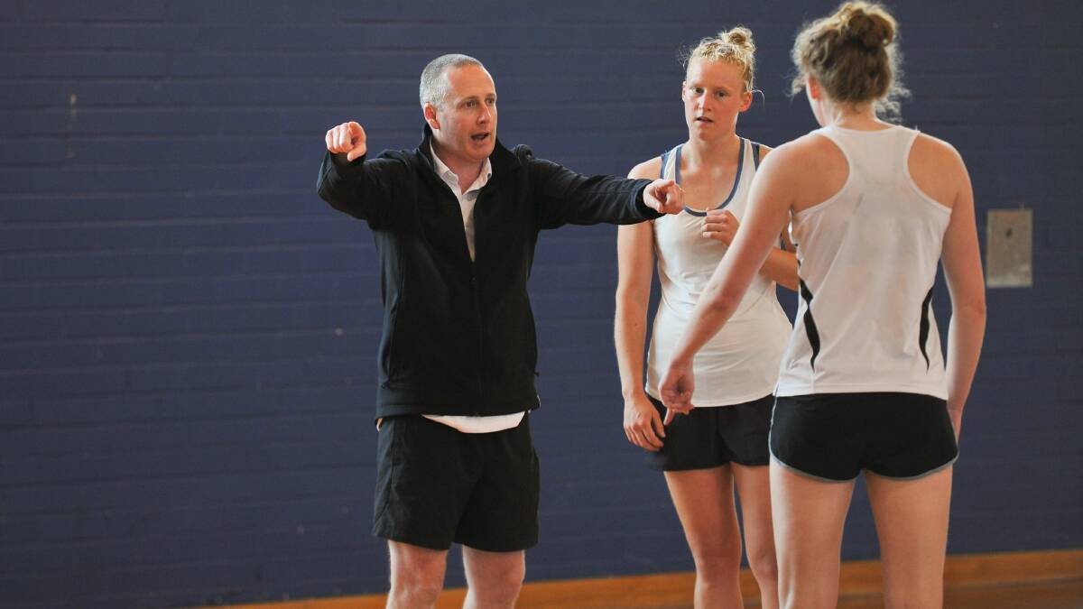 TAKE MY WORD: Pidgeon talks to netballers that played under him for the Tasmanian Magpies this year. Pictures: Scott Gelston
