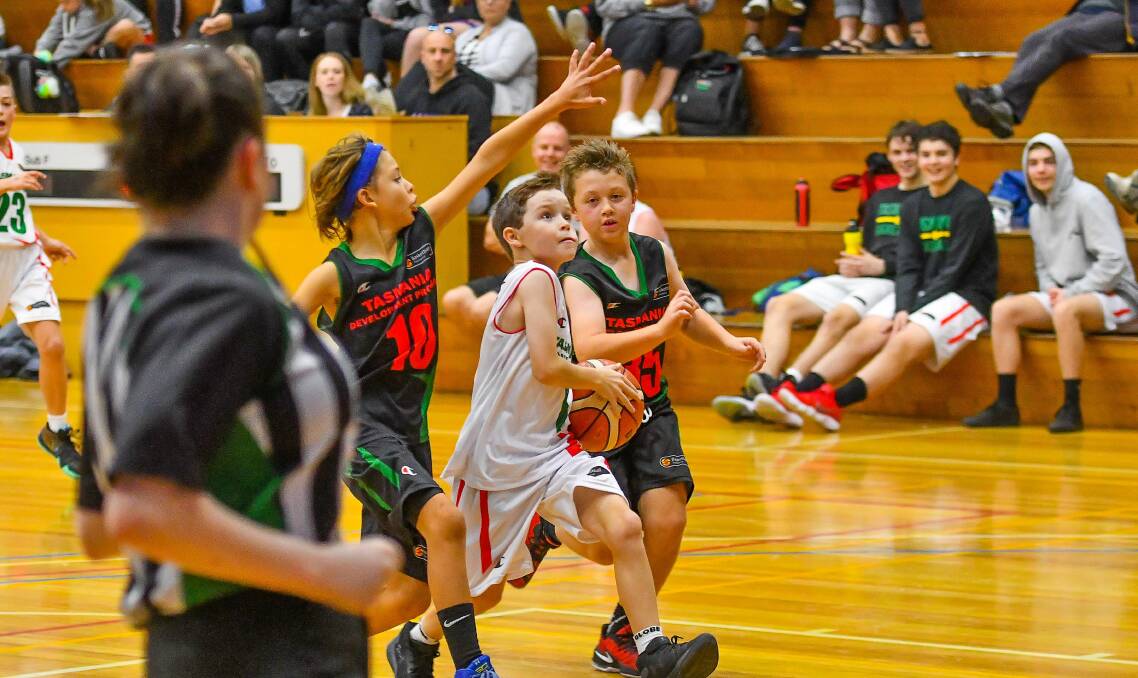 LAY-UP: Angus Wilcox heads to the basket for South Green against North West Black in one of the weekend's under-12 games.