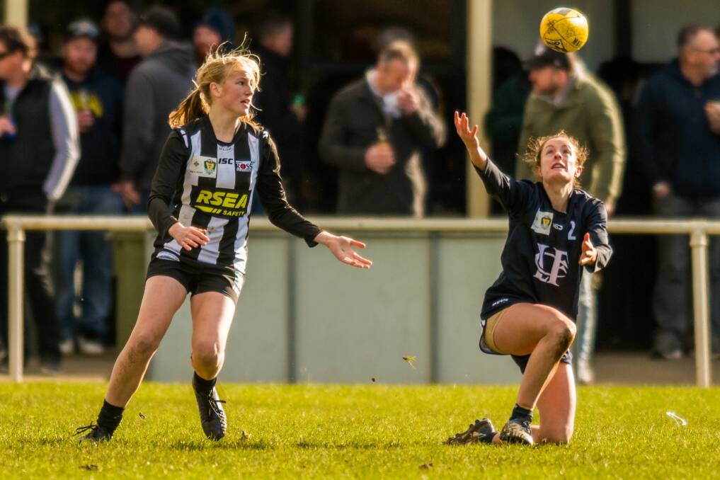 JUGGLING ACT: Blues campaigner Angela Dickson looks to cling onto a mark during the wild and windy conditions at Evandale.