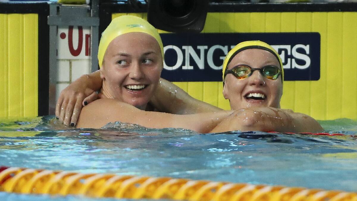 YOU BEAUTY: Tasmanian Ariarne Titmus, left, celebrates after winning gold at the Women's 800m freestyle final on Monday night.