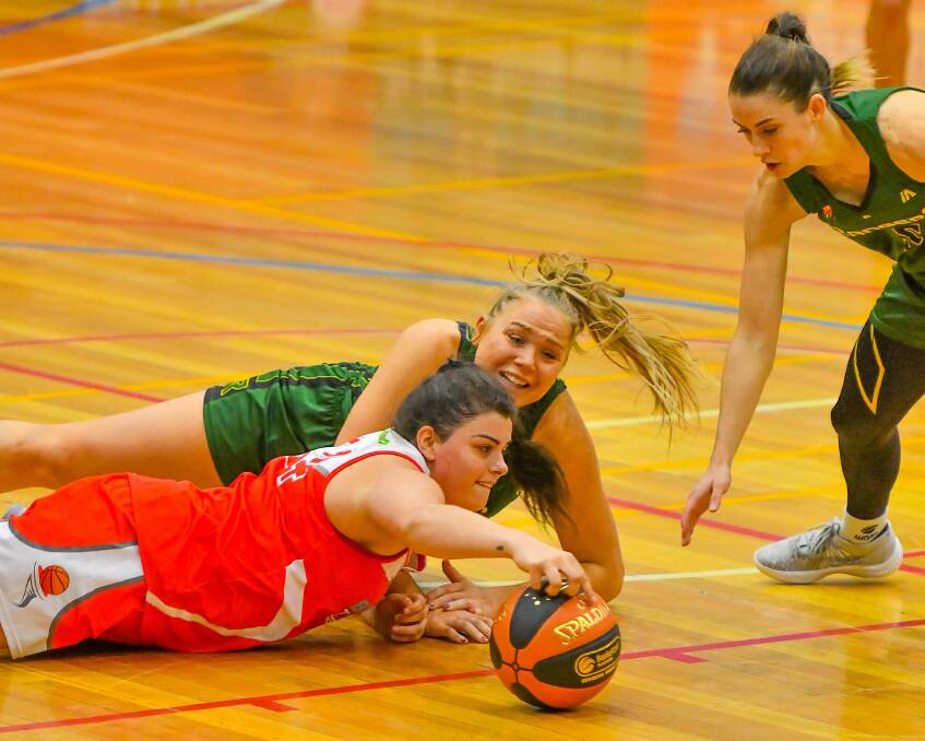 DESPERATION: Outgoing Tornadoes star Ellie Collins fights for possession against former teammate Tayla Roberts last year. 