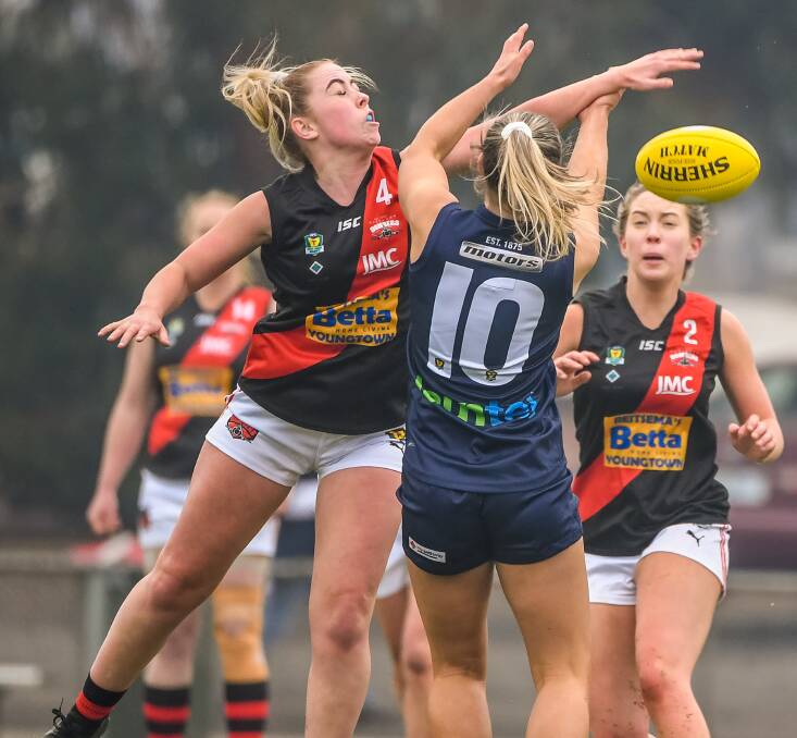 CONTESTED BALL: North Launceston forward Hayley Breward puts on fierce defensive pressure in the Bombers' opening encounter of the TSLW season against Launceston.