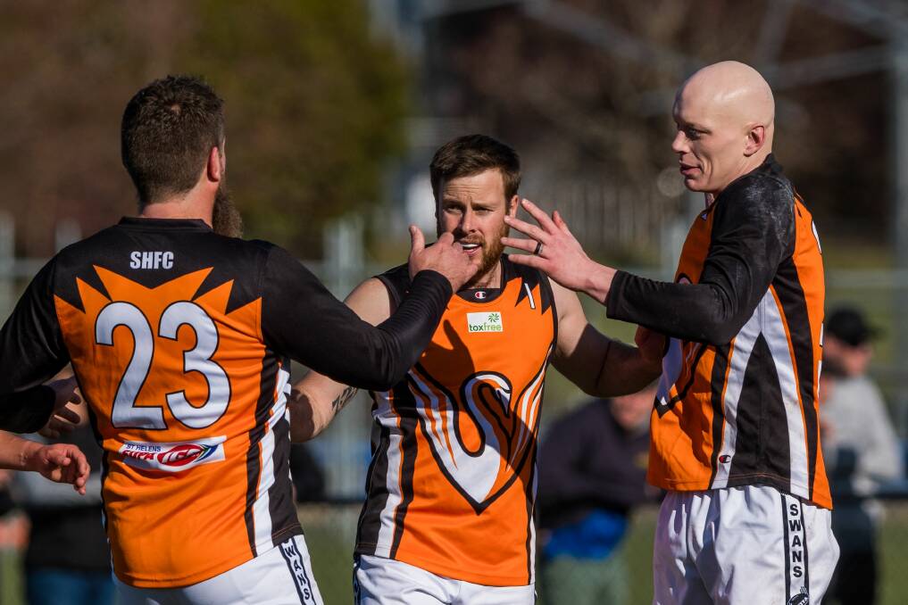 HOW GOOD IS THIS: East Coast danger forwards Gene Savage, Nick Child and Will Stoltenberg celebrate another Swans goal. Picture: Phillip Biggs