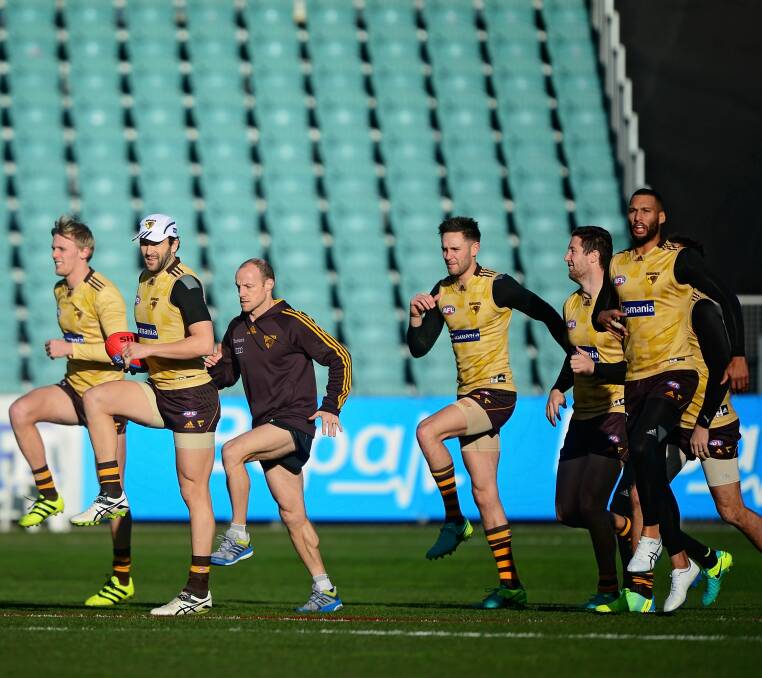 LOOSEN UP, FELLAS: Hawthorn goes through their stretches at the side's final warm up session on Friday afternoon.