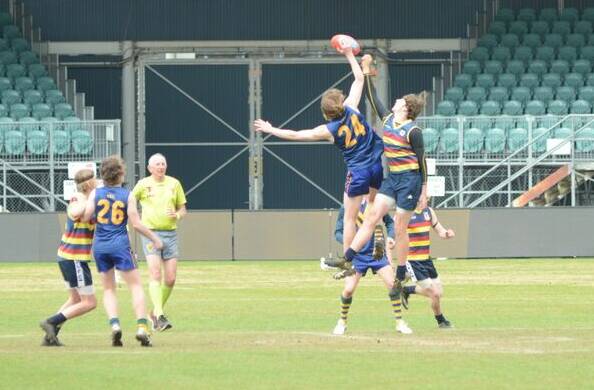 BIG MEN FLY: Riverside and St Virgil's do battle at the opening bounce of the final. Picture: Supplied