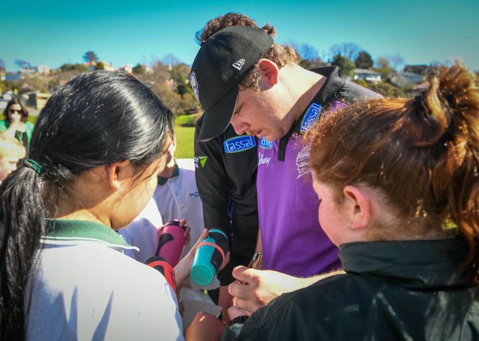 IN DEMAND: Jarryd Freeman signs autographs at East Launceston Primary School pupils in a Cricket Tasmania preseason visit. Picture: Paul Scambler
